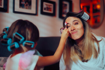 Little Girl Does Her Mom Make-up with a Brush Tickling Her. Mother and daughter having fun together playing with cosmetics

Mother and daughter having fun together playing with cosmetics