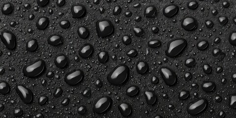 Close-up of glossy, reflective water droplets on a dark, textured surface, creating a dynamic visual