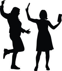 Two women silhouetted one dancing and the other taking a photo with
