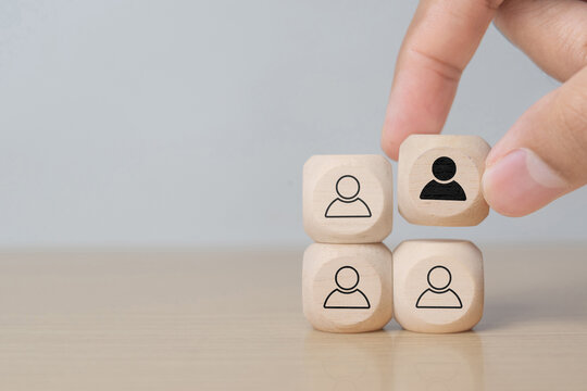 Hand holding a block diplaying a new member of the team - Business solutions for teams, complete puzzle, missing block