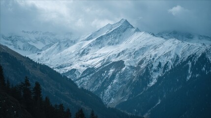 Snow Covered Mountain Range Under Cloudy Sky During Winter Season