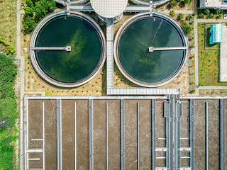 Aerial top down view of sewage water treatment plant with biological cleaning tanks.