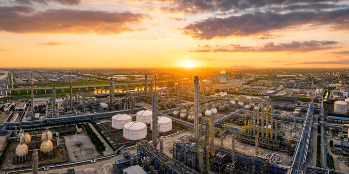 Modern chemical plant and oil refinery industrial landscape at dramatic beautiful golden sunset.