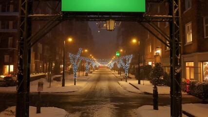Snowy City Street at Night with Festive Lights and a Green Screen Billboard Overlay for Customization