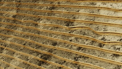 Textured Soil with Wavy Patterns. High-quality image with clean composition and soft lighting. Ideal for web design, presentations, branding, social media and print.