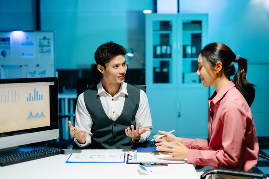 Professional coworkers discussing data and analyzing business reports in a modern office of teamwork, strategy, and corporate collaboration. - Powered by Adobe