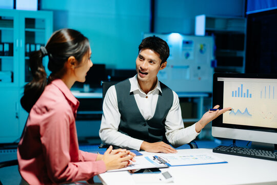 Professional coworkers discussing data and analyzing business reports in a modern office of teamwork, strategy, and corporate collaboration.