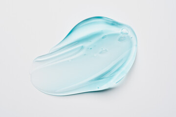 blue transparent liquid gel on white background. Cosmetic skincare product texture. Face cream, body lotion swipe swatch
