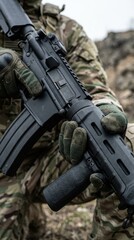 Obraz premium Military Soldier Holding Assault Rifle with Tactical Gear Outdoors