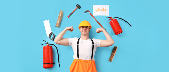 Male firefighter with equipment showing muscles on blue background, top view