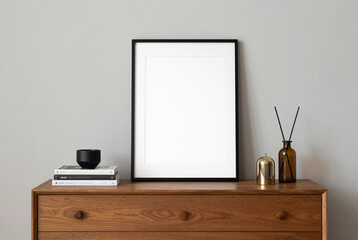 Framed poster sits on a dresser next to a cup of coffee.