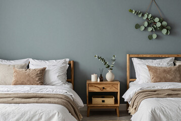 Bedroom with two beds and a nightstand.