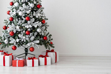 Christmas tree with presents under it in a room