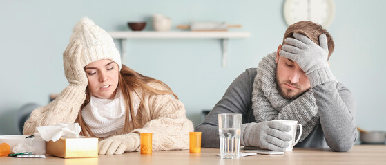 Sick couple sitting at kitchen table