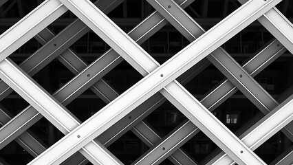 disequilibrium. Structural lattice of intersecting steel I-beams forming a repeating geometric pattern. real-estate listings.