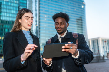 Diverse business colleagues reviewing data on a digital tablet