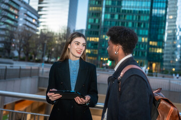 Business colleagues having a corporate discussion in city street