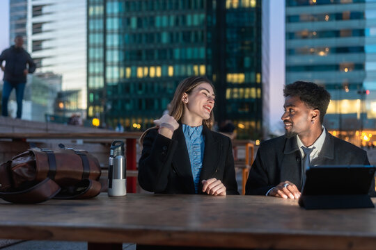 Diverse coworkers communicating after work in business district - Powered by Adobe