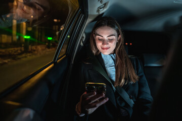 Young woman enjoying digital connection during night car ride