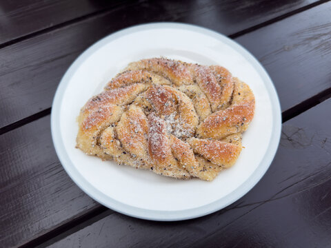 Still life of Swedish cardamom bun (kardemummabullar) on plate
