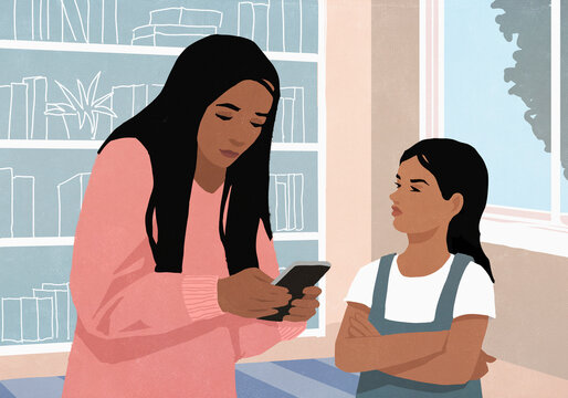 Angry daughter watching mother using smart phone at home
