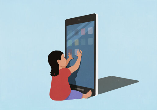 Curious toddler girl playing with large digital tablet, touching screen against blue background
