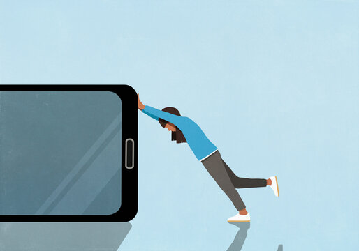 Girl pushing large smart phone against blue background
