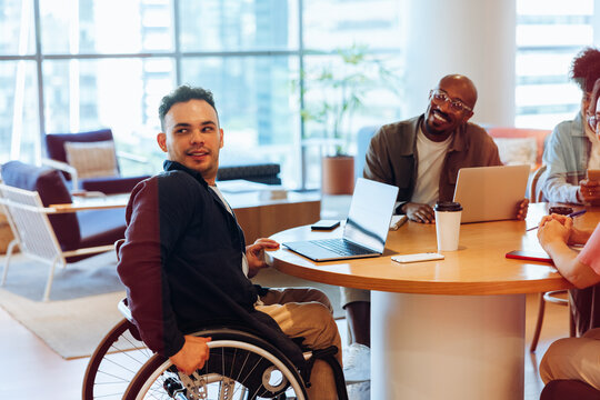 Friends collaborate at a round table in office