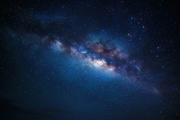 Obraz premium Milky Way Galaxy filled with thousands of stars shining brightly in the night sky over a tranquil landscape