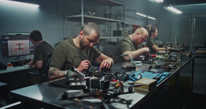 Modern Manufacturing Facility Bustles With Skilled Workers Various Stations, Building FPV Drones. Concept of Precision and Complexity of Modern Industrial Production and Technological Advancement.