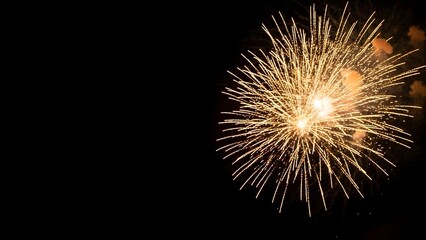 Golden fireworks exploding in the night sky celebration event