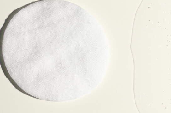 A cotton pad for removing makeup and micellar water.