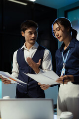 Financial analysts work overtime analyzing data on tablets, laptops, and graphs. Collaboration,...