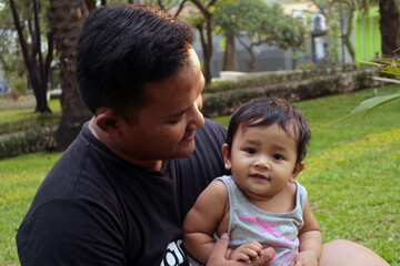 Happy Dad and Toddler Bonding Outdoors