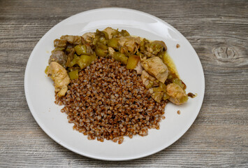 A traditional Eastern European dish served for lunch. An appetizing presentation in a deep bowl against the texture of a wooden table or countertop creates a cozy atmosphere.