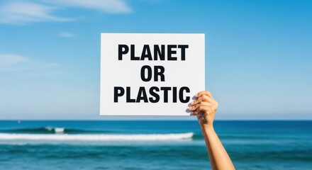 Woman holds a sign with planet or plastic message at the beach. Environmental awareness concept for world clean up day. Stop ocean pollution.