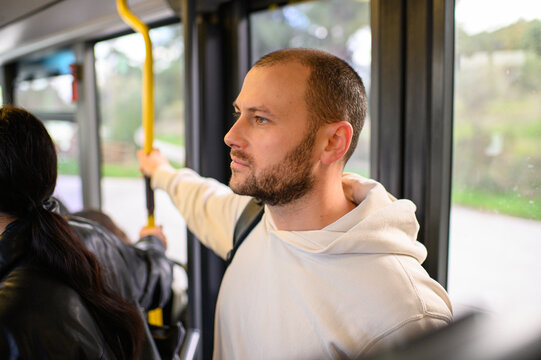 Man riding a bus and validating his ticket on public transport, commuting, urban daily routine, city lifestyle and transportation concept.