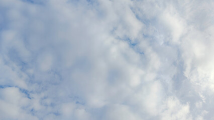 Soft White Clouds and Pastel Blue Sky Background on a Partially Cloudy Day