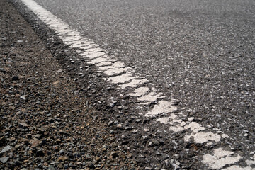 Cracked road marking on asphalt surface