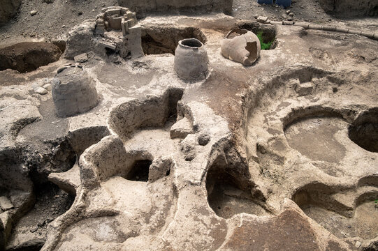 Clay jars and pottery fragments uncovered at an ancient excavation site in Gabala, Azerbaijan, under daylight.