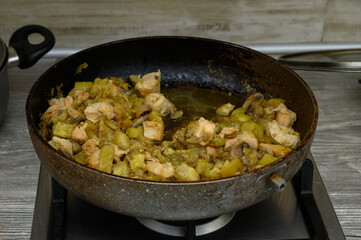 Chicken and Zucchini Stir-Fry Cooking in a Pan on a Kitchen Stove. Cooking Process.1