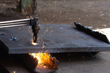 Hot Sparks During Steel Cutting with Oxy-Fuel Torch in Industrial Workshop