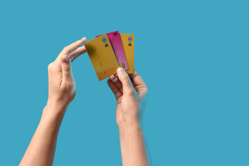 Hands with credit cards on blue background