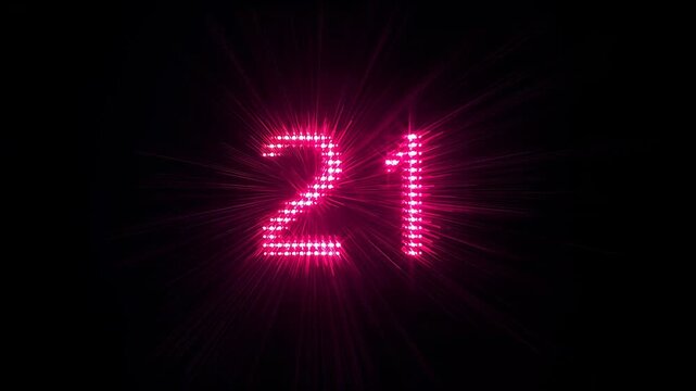Displaying magenta LED digits 21 pulsing from lens diffraction in dark room, with shifting flare