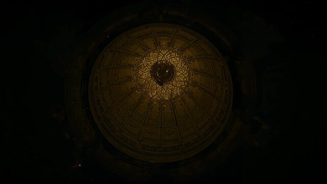 Warm light expanding revealing ornate domed ceiling in palace, central chandelier and radial ribs