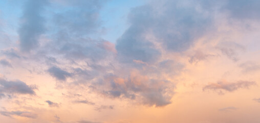 Beautiful blue sky with a few clouds and a pinkish hue