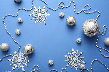 Frame made of disco balls and Christmas decor on blue background