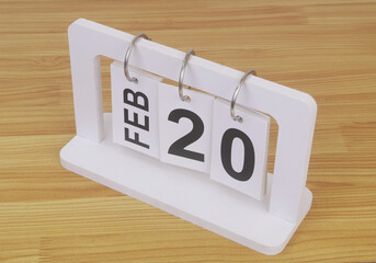 February, 20 on calendar on wooden table close-up.	