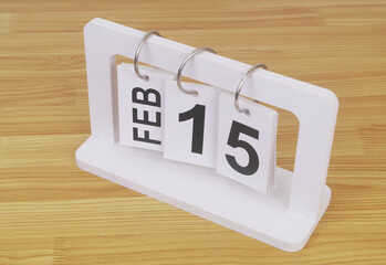February, 15 on calendar on wooden table close-up.	
