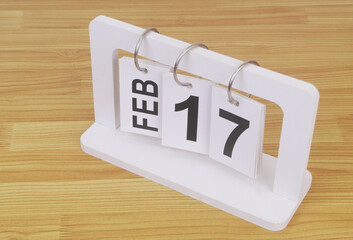 February, 17 on calendar on wooden table close-up.	